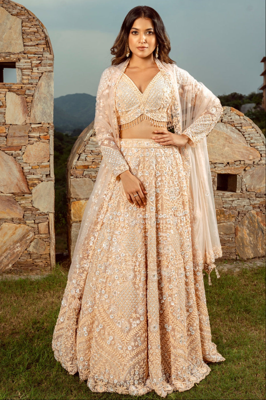 Peach net lehenga choli with sequins and hand cut dana work