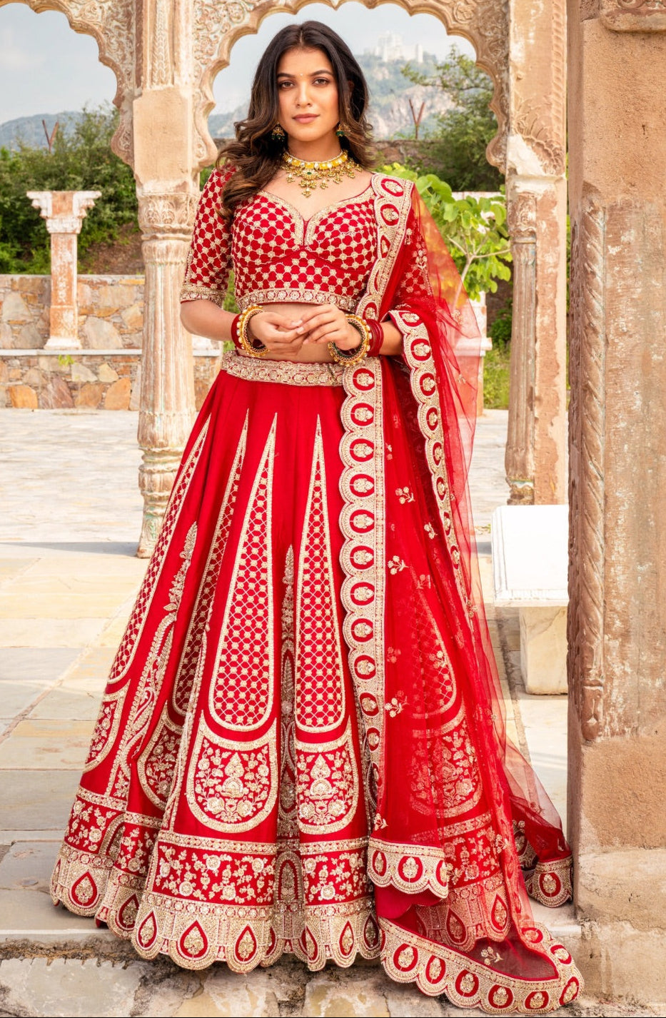 Bright red raw silk bridal lehenga choli with hand cut dana work
