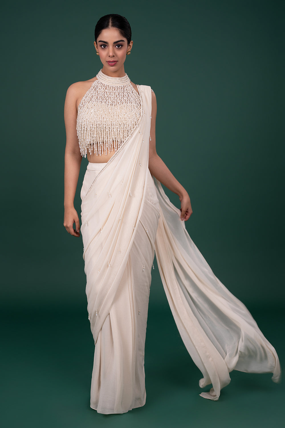 Cream Georgette saree with pearl encrusted halter blouse