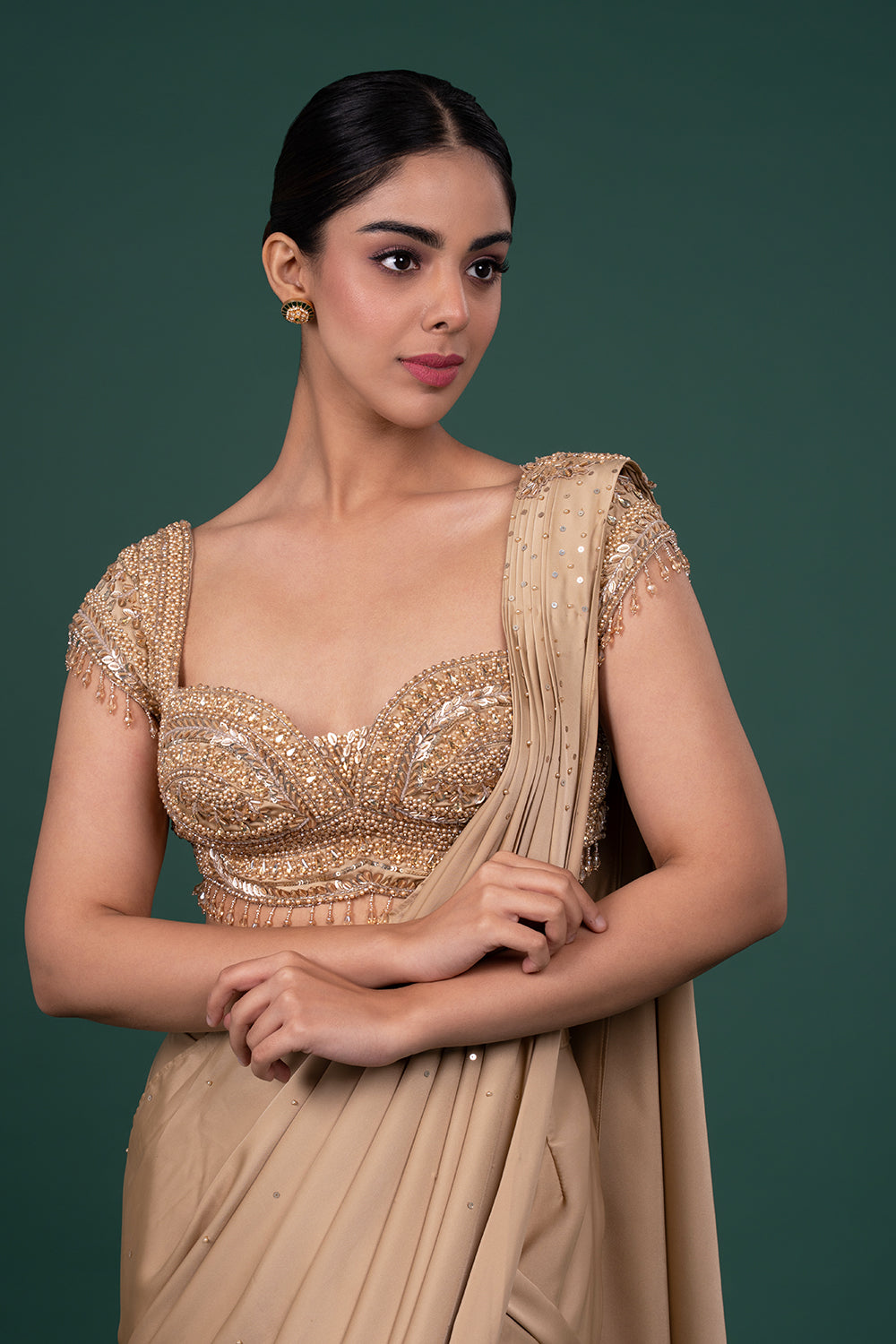 Metallic gold satin saree with heavily embellished cap sleeve blouse