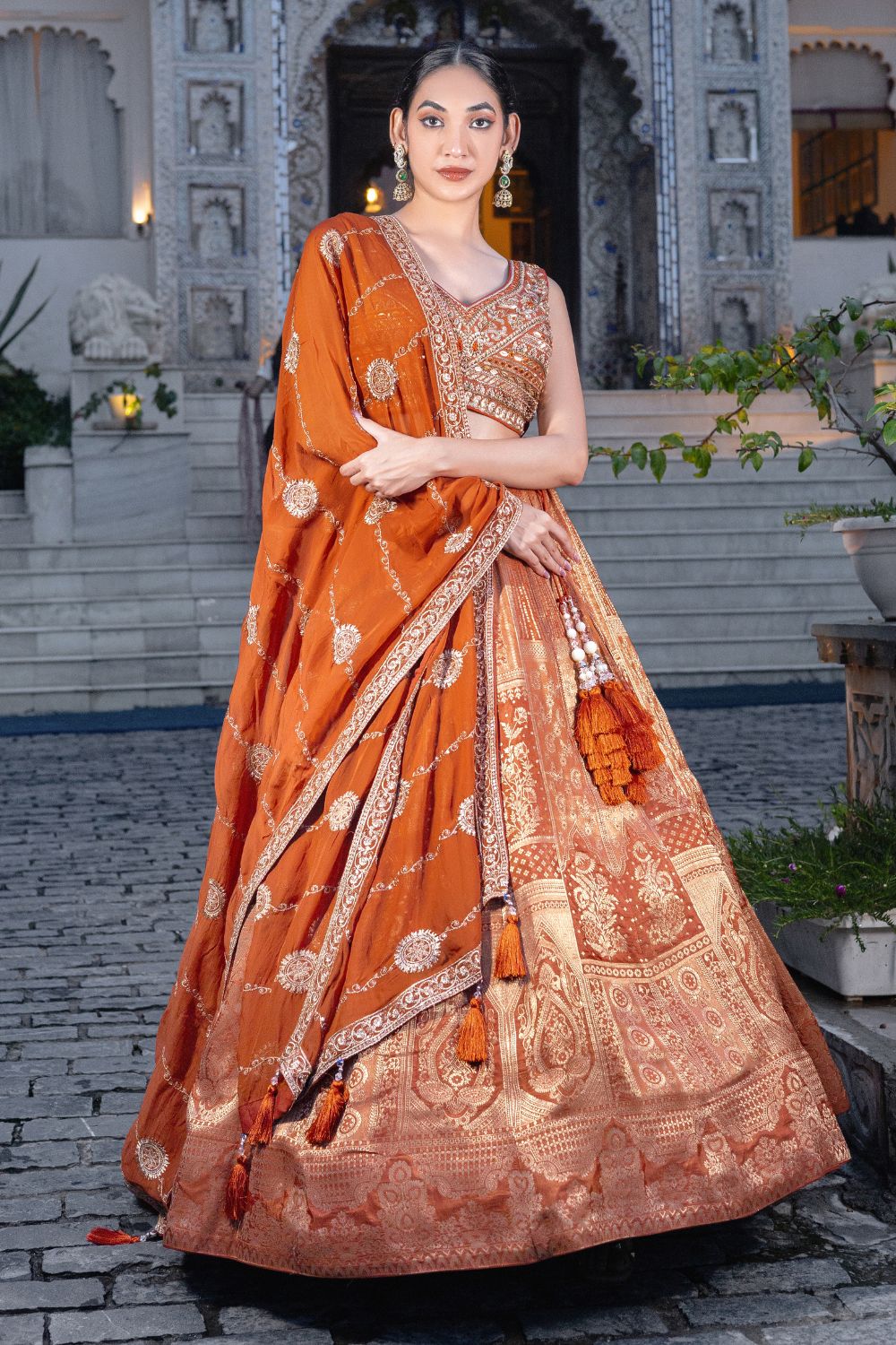 ORANGE BANARSI SILK LEHENGA CHOLI WITH WEAVING AND MIRROR WORK