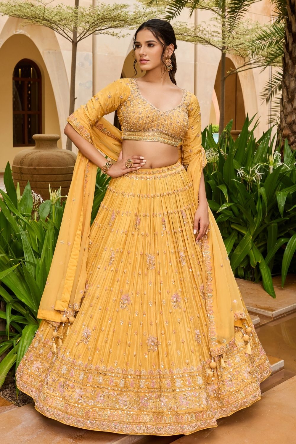Yellow silk lehenga choli with sequins and hand cut dana work