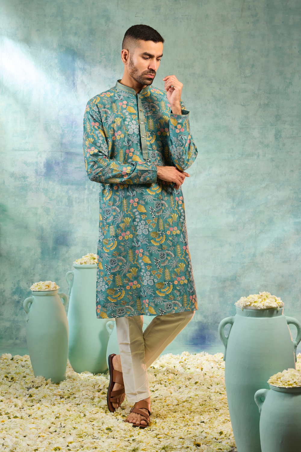 Teal kurta set with multi colour thread work and cream coloured bottoms