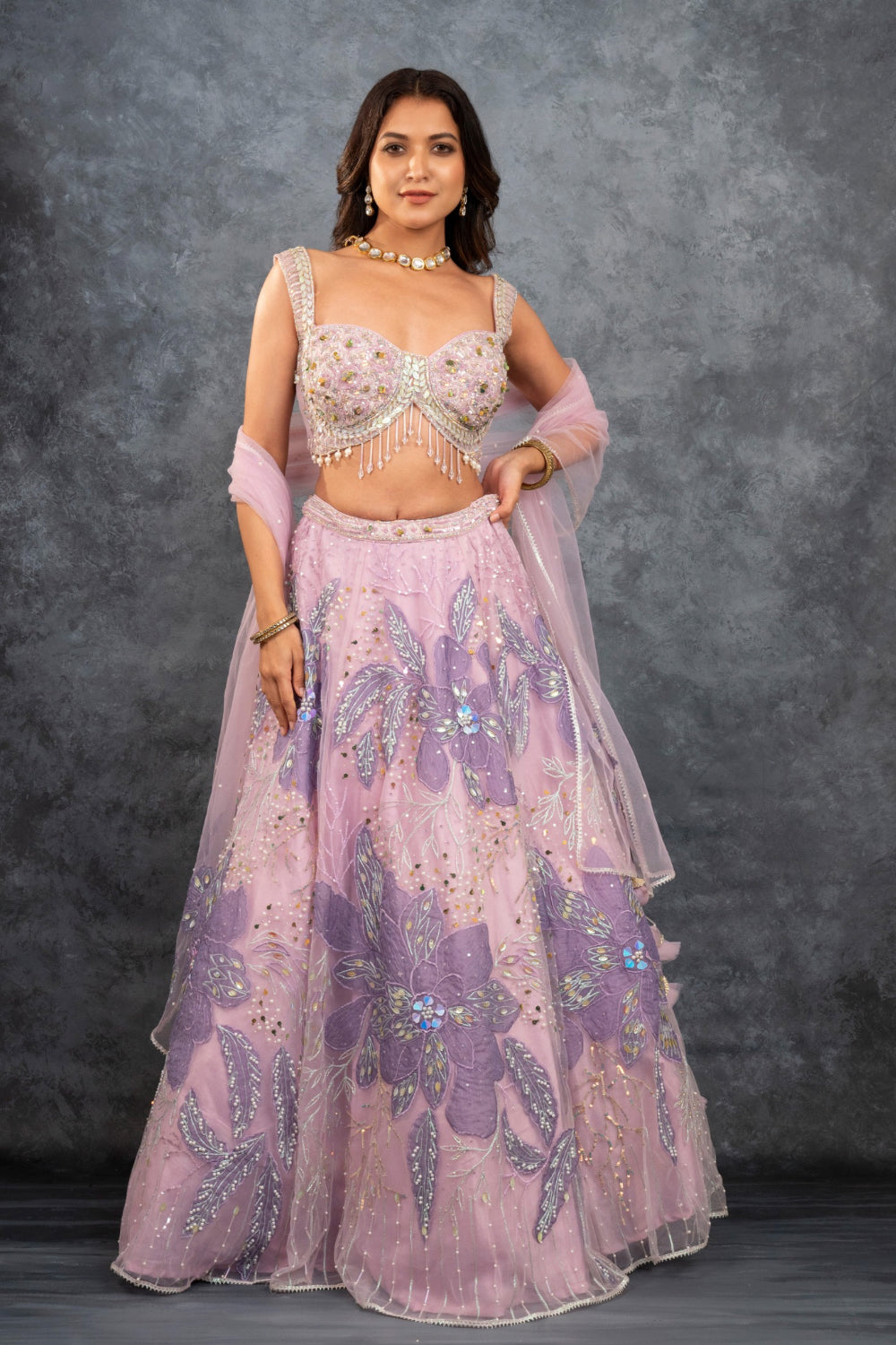 Baby pink net lehenga choli with sequins, hand-cut dana, and pearl accents