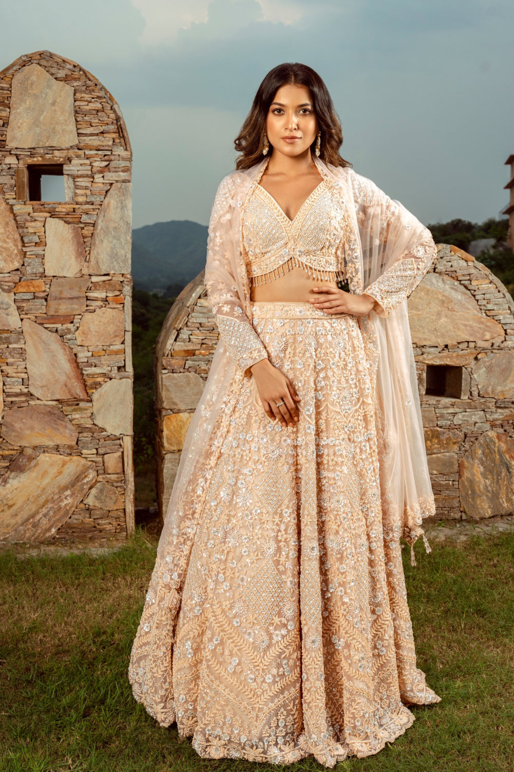 Peach net lehenga choli with sequins and hand cut dana work