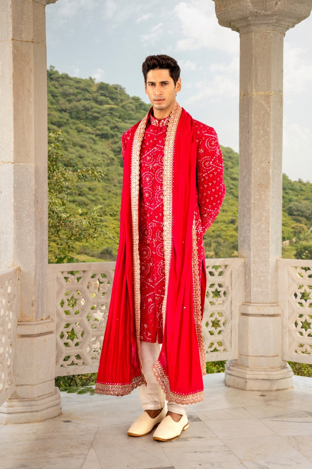 Vibrant red silk sherwani with hand cut dana and sequins work