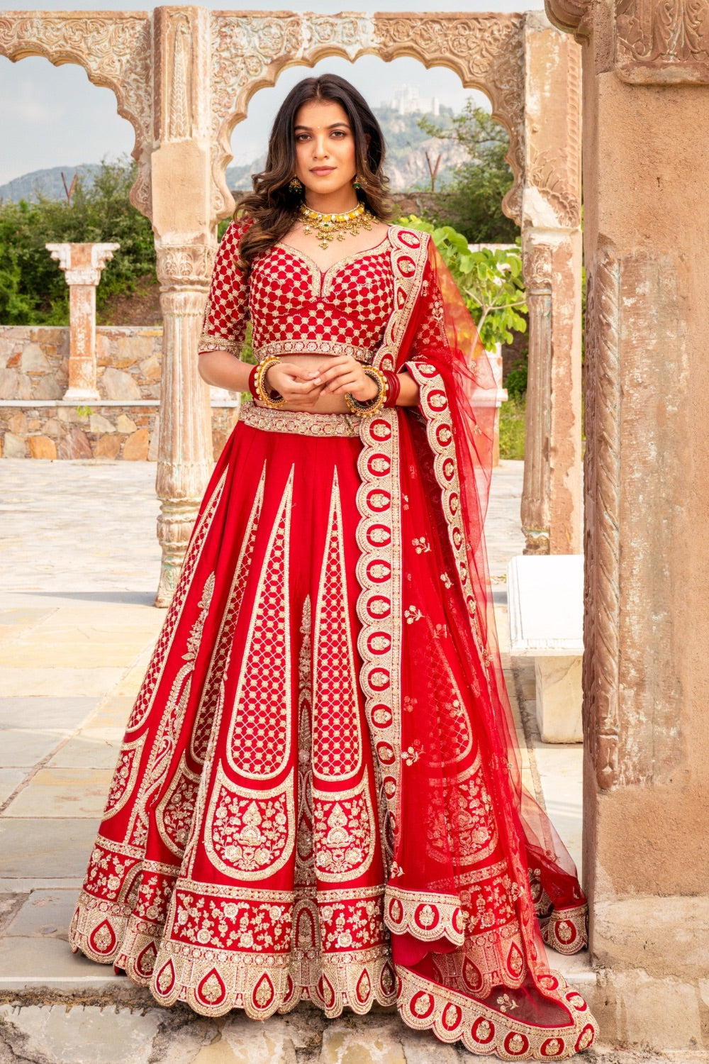 Bright red raw silk bridal lehenga choli with hand cut dana work