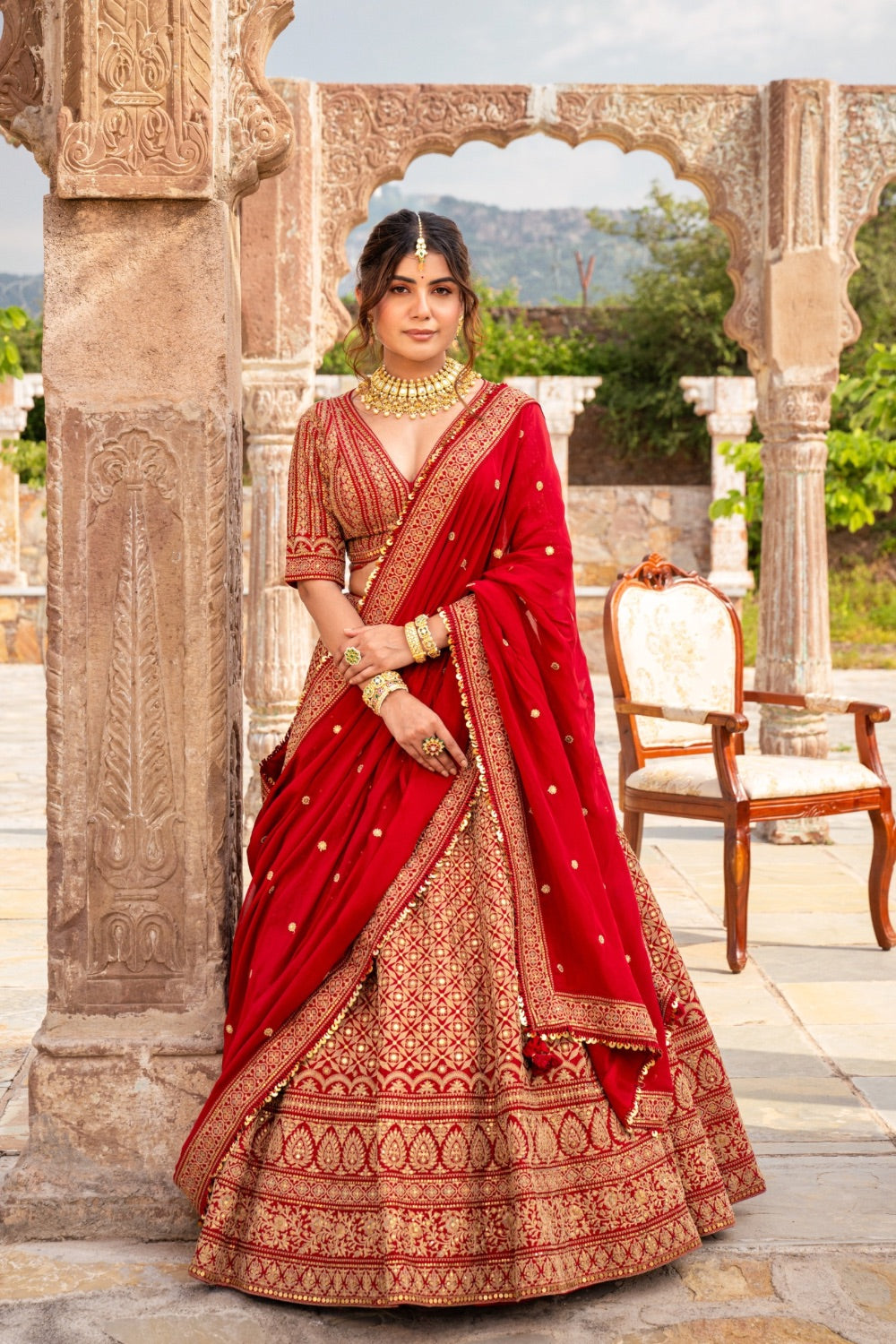 Cherry red raw silk bridal lehenga choli with marodi work