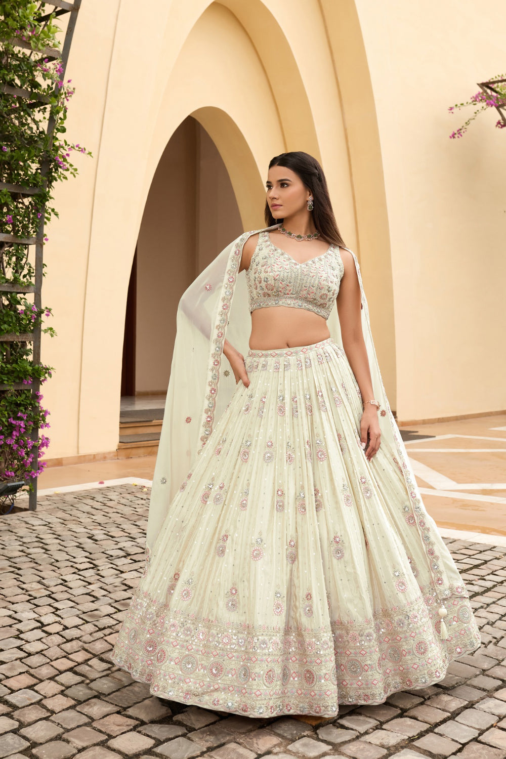 Off-white georgette lehenga choli with hand cut dana and sequins work