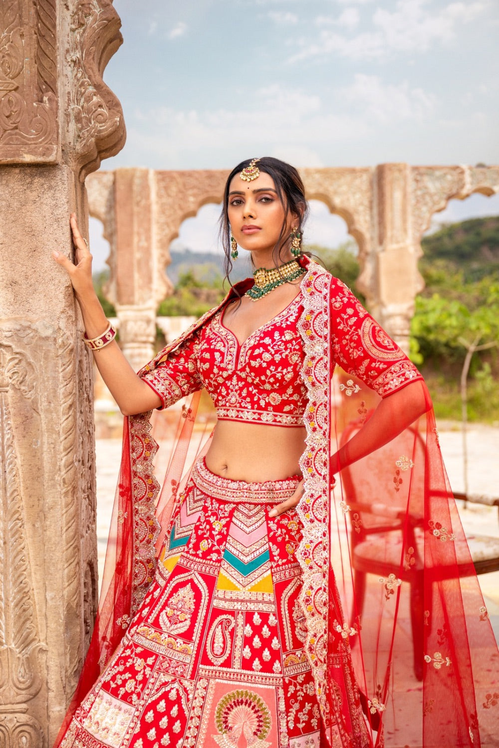 Bright red silk lehenga choli with hand thread work and moti work