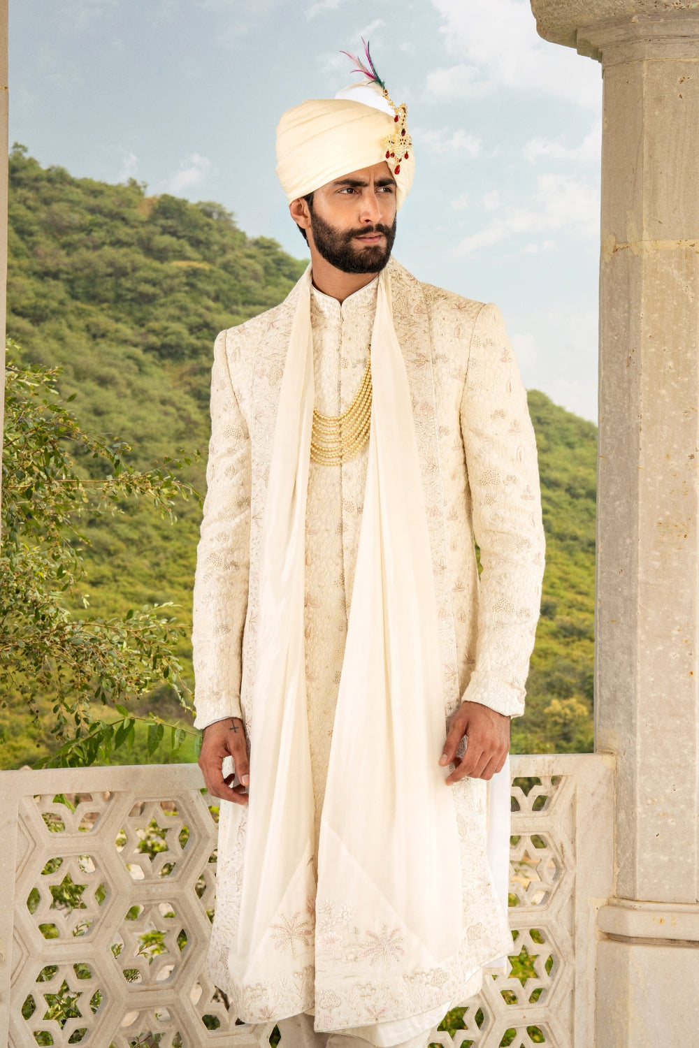 White silk sherwani with golden zardozi embroidery and moti work