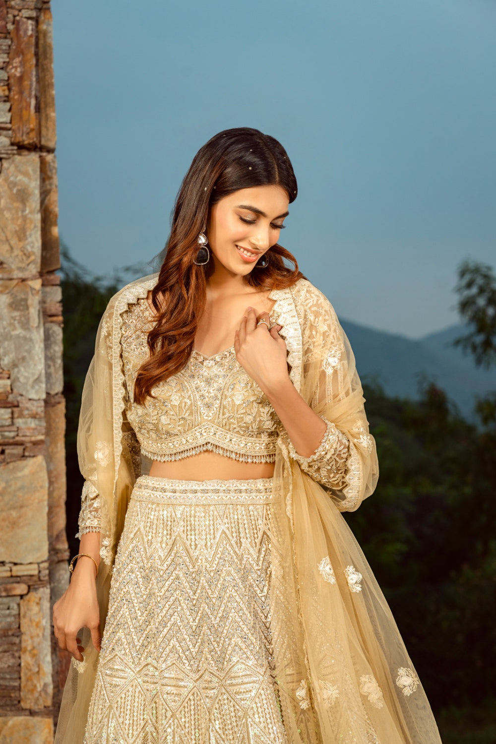 Golden net lehenga with sequins and hand cut dana work