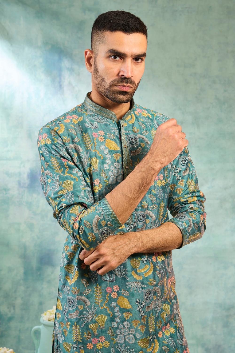 Teal kurta set with multi colour thread work and cream coloured bottoms