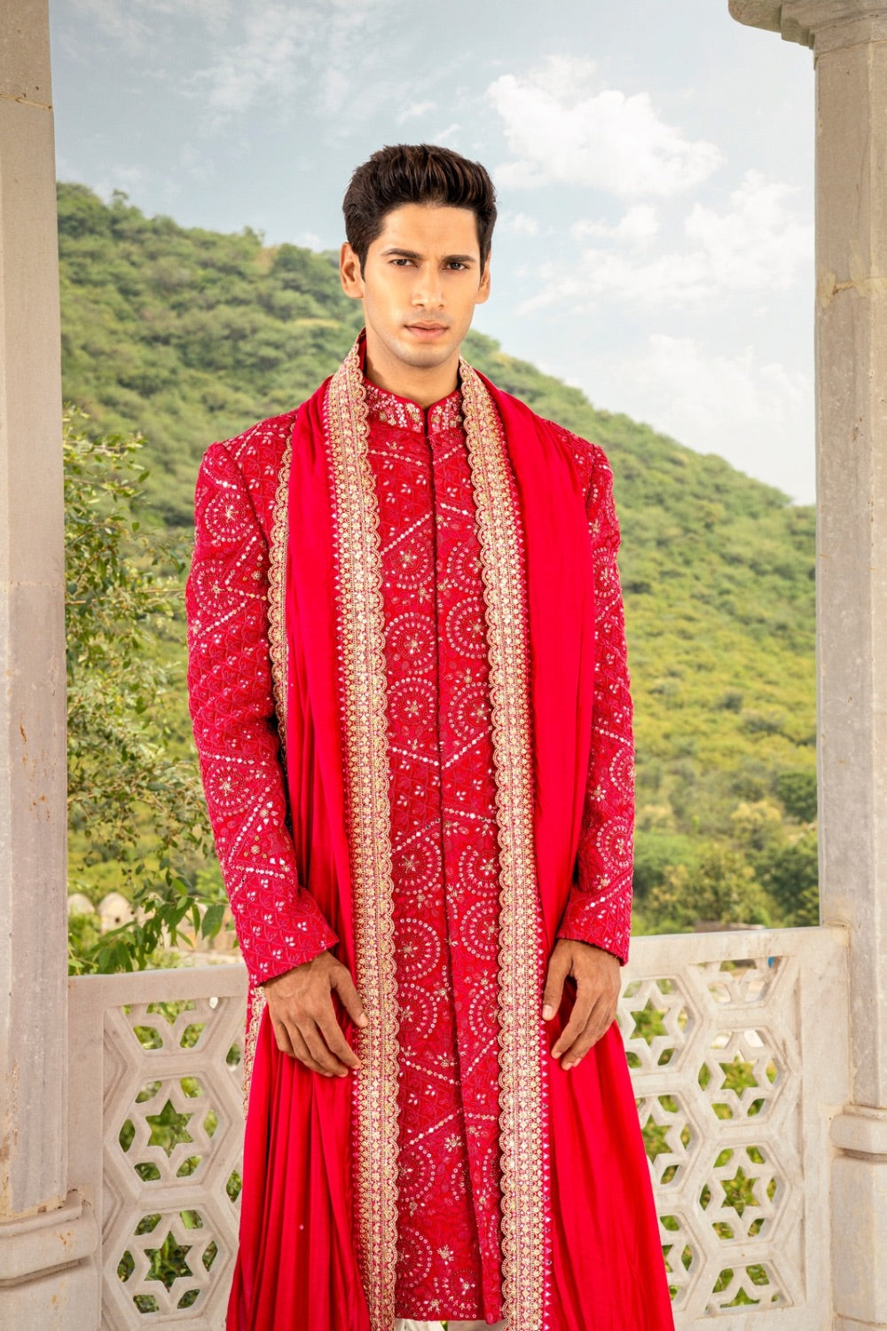 Vibrant red silk sherwani with hand cut dana and sequins work