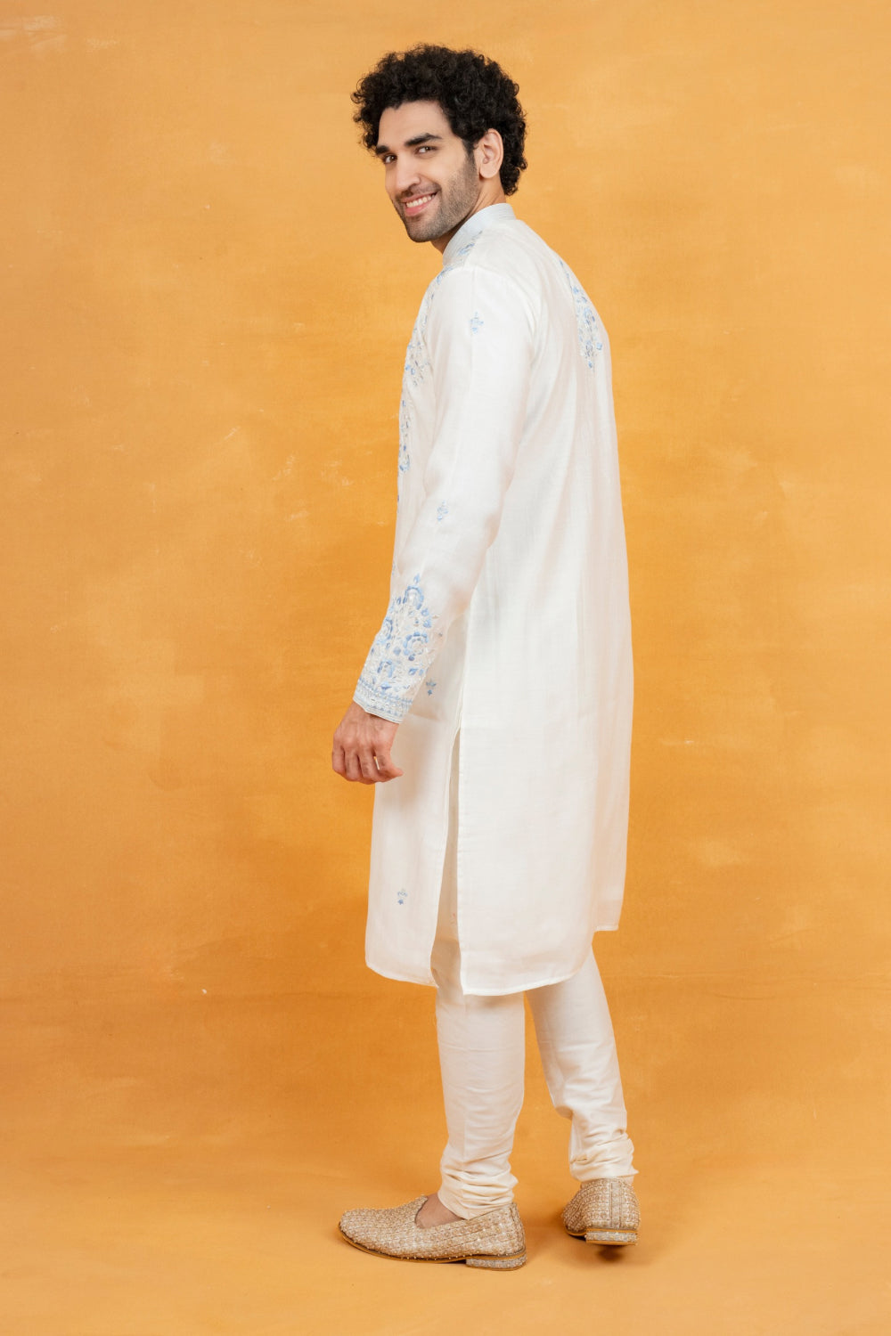 Cream silk kurta set with blue resham embroidery and mirror work