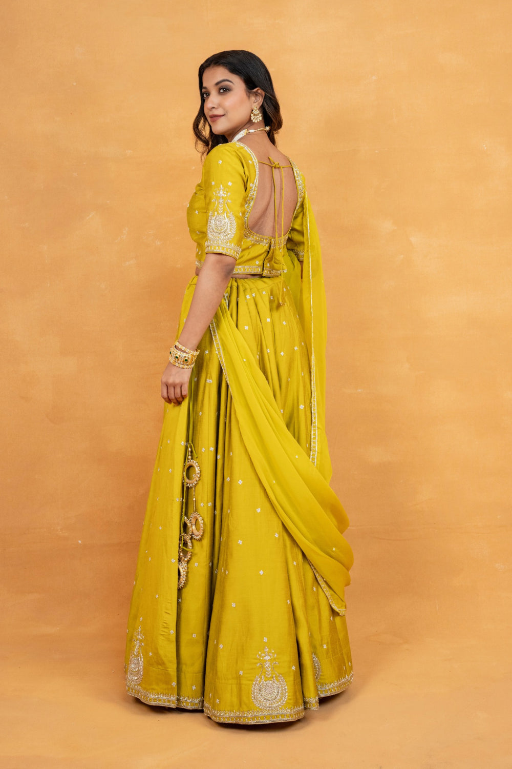 Mustard yellow soft silk zardozi embroidered lehenga choli with hand cut dana and sequin work