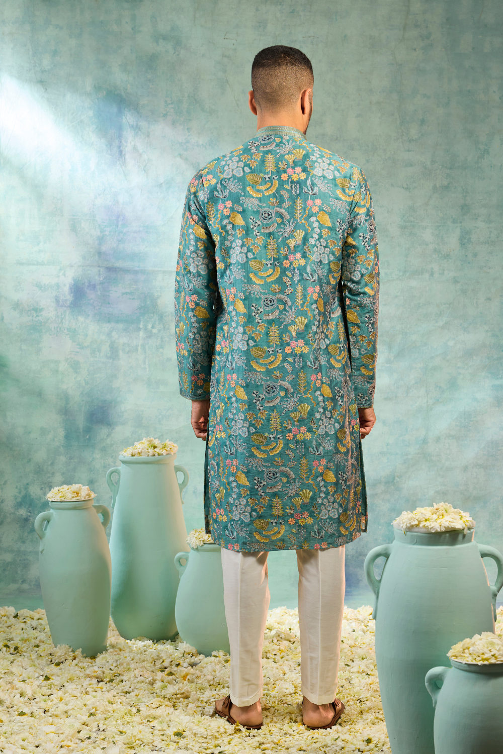 Teal kurta set with multi colour thread work and cream coloured bottoms