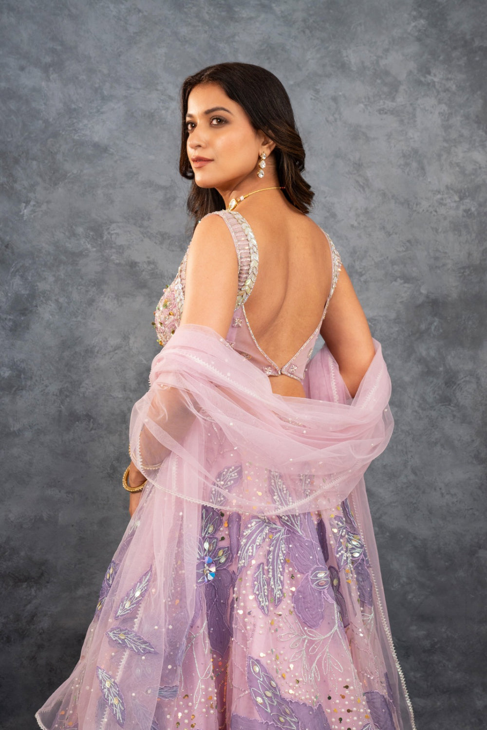 Baby pink net lehenga choli with sequins, hand-cut dana, and pearl accents