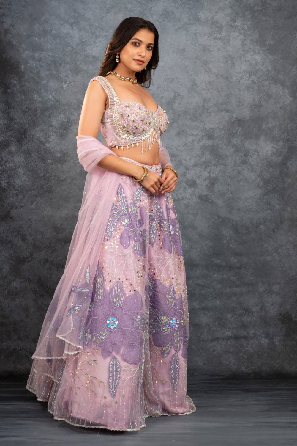 Baby pink net lehenga choli with sequins, hand-cut dana, and pearl accents