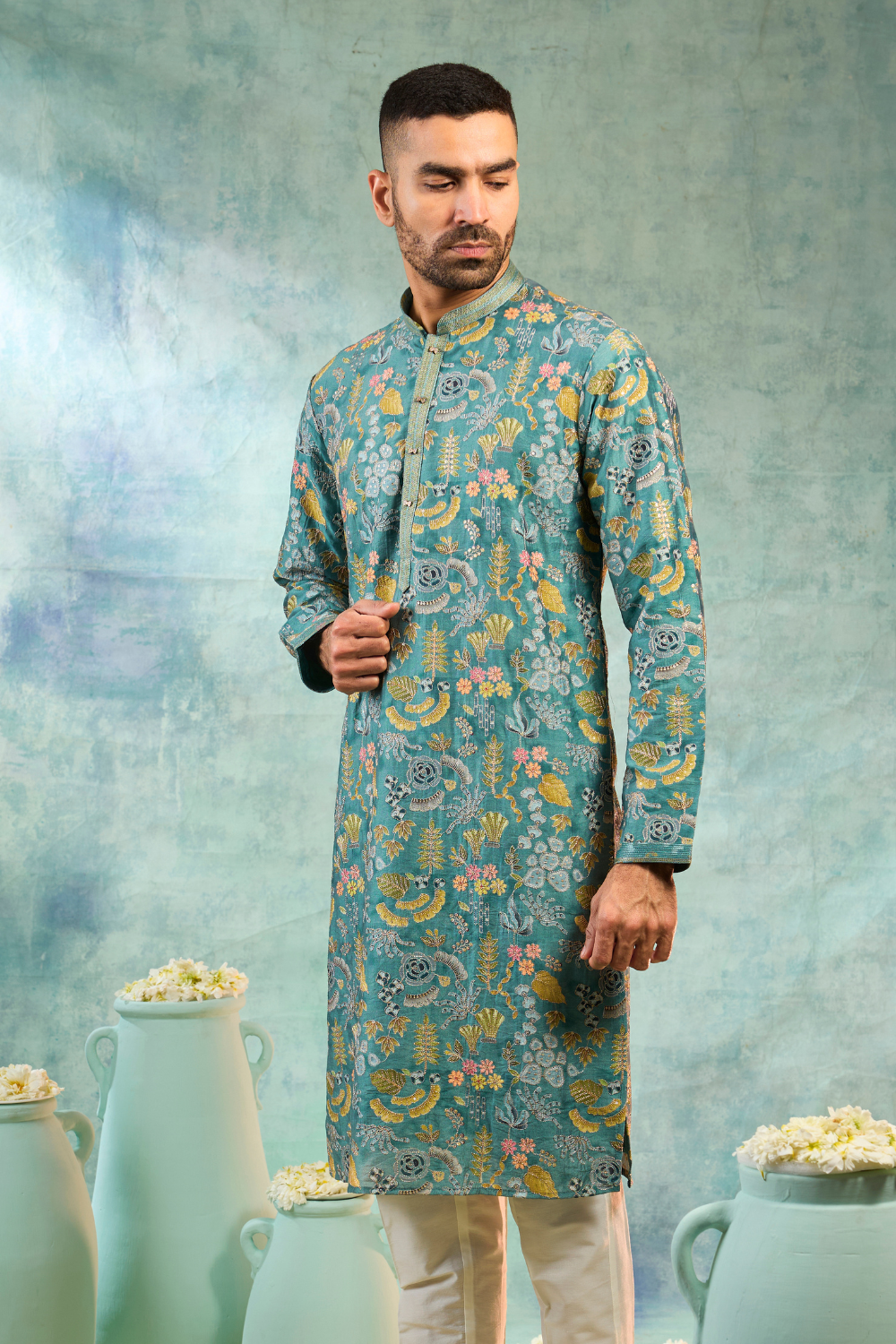 Teal kurta set with multi colour thread work and cream coloured bottoms