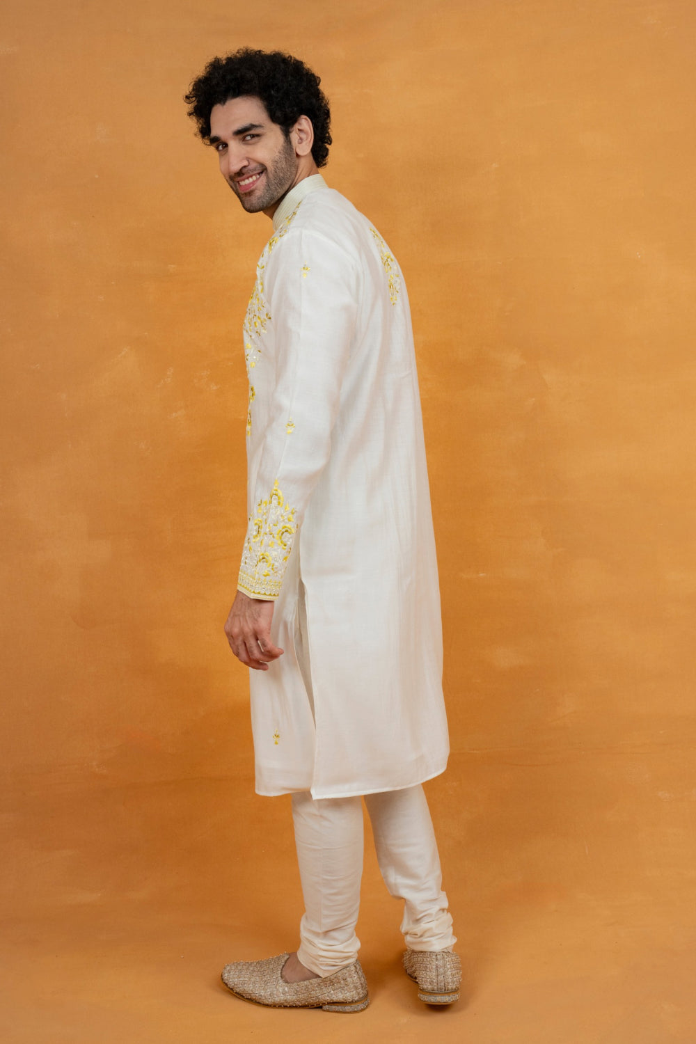 Cream silk kurta set with yellow resham embroidery and mirror work