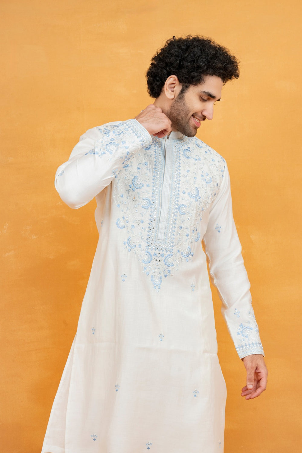 Cream silk kurta set with blue resham embroidery and mirror work