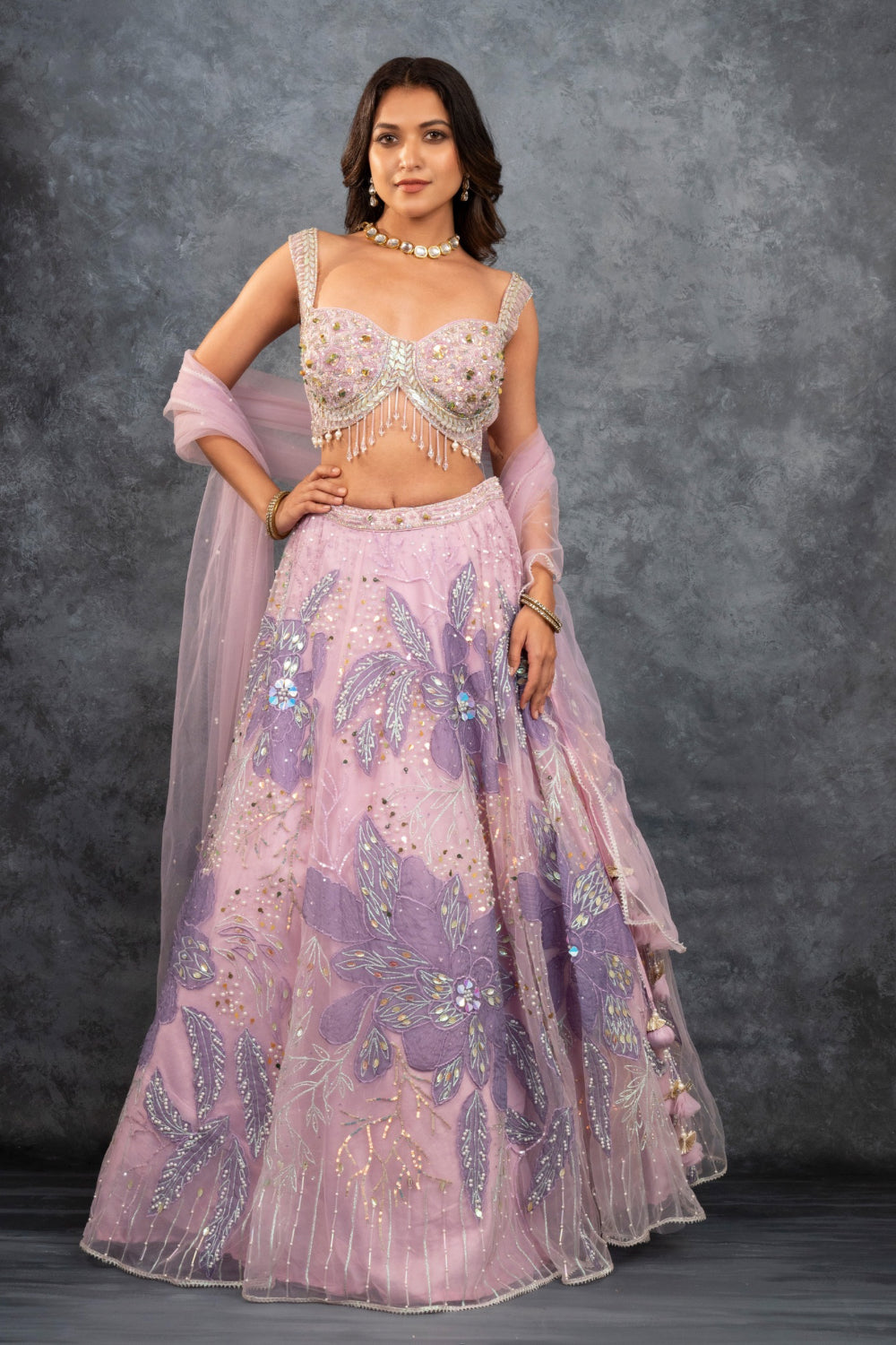 Baby pink net lehenga choli with sequins, hand-cut dana, and pearl accents