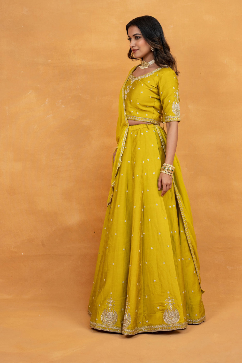 Mustard yellow soft silk zardozi embroidered lehenga choli with hand cut dana and sequin work