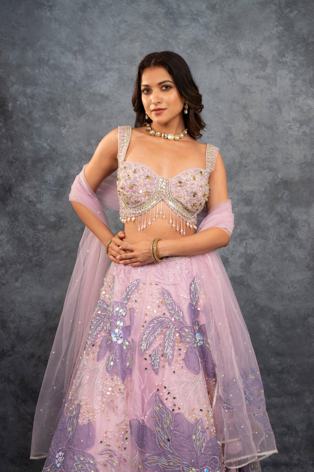 Baby pink net lehenga choli with sequins, hand-cut dana, and pearl accents