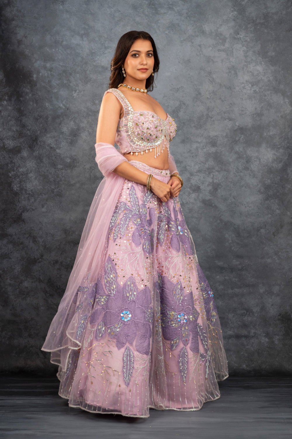 Baby pink net lehenga choli with sequins, hand-cut dana, and pearl accents