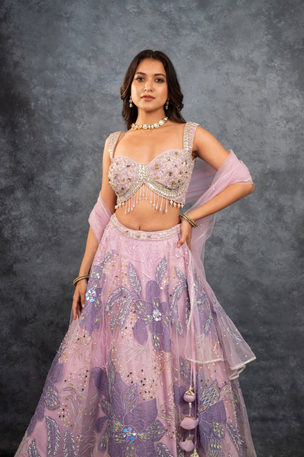 Baby pink net lehenga choli with sequins, hand-cut dana, and pearl accents