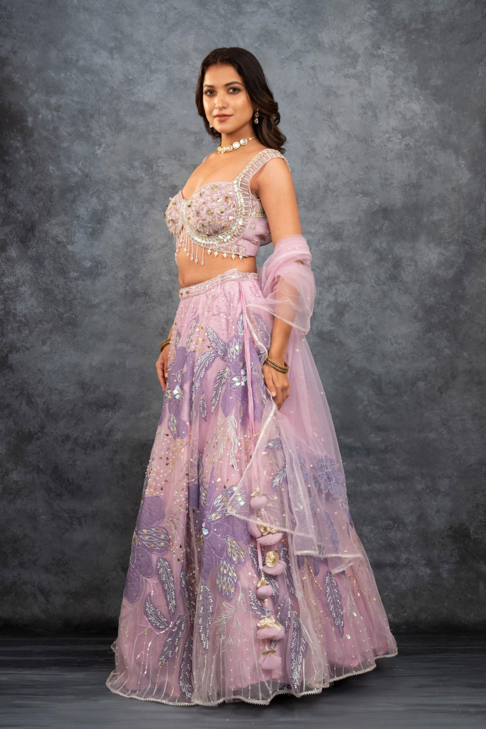 Baby pink net lehenga choli with sequins, hand-cut dana, and pearl accents