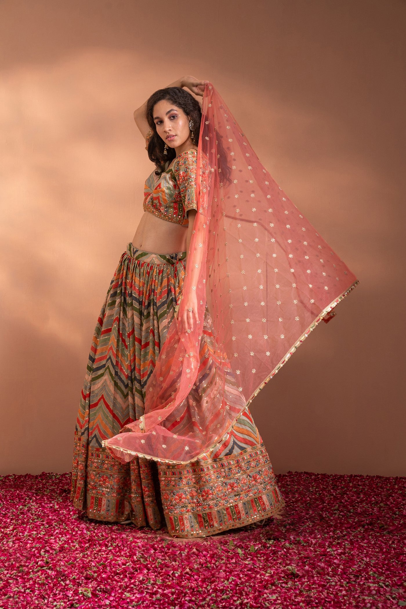Multi Colour Lehenga set in Cotton-Satin Fabric with heavy threadwork, sequence, arri work & Net Dupatta.