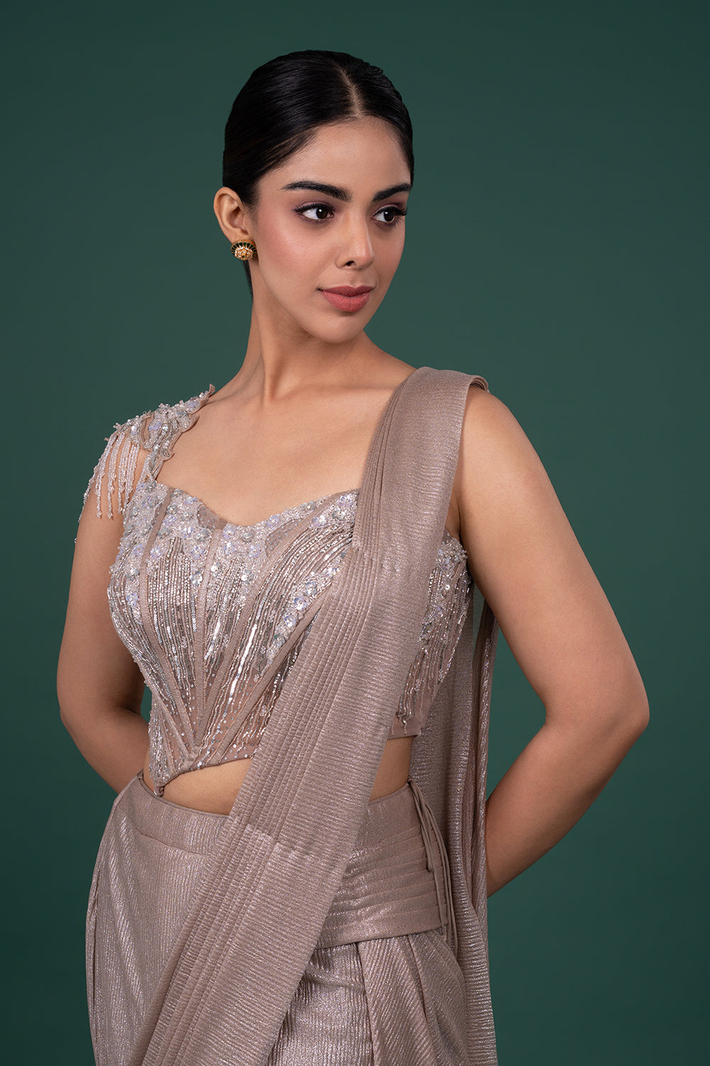Metallic Pre-Draped Shimmer Saree with Asymmetrical Embellished Corset Blouse.