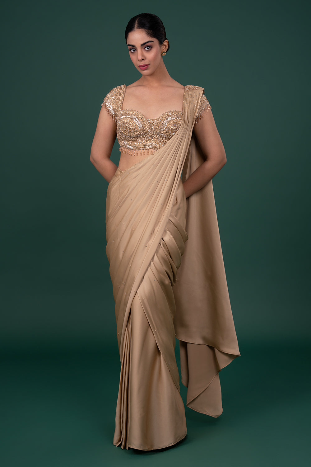 Metallic gold satin saree with heavily embellished cap sleeve blouse